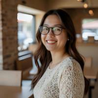 Happy female entrepreneur smiling at coffee shop after completing chak.ai Shopify course