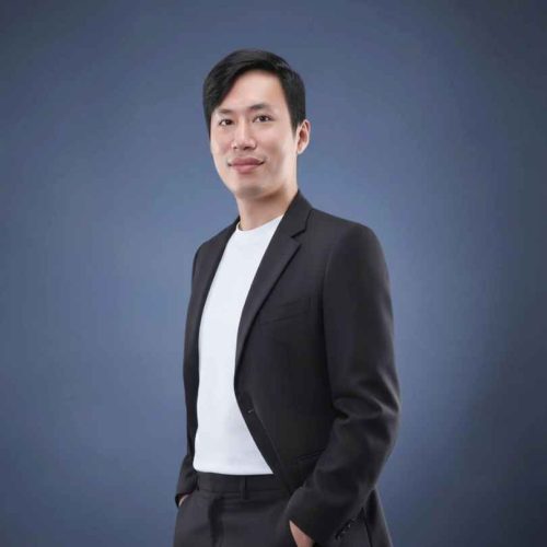 Michael Chak, eCommerce strategist and founder of chak.ai, standing confidently against a blue background